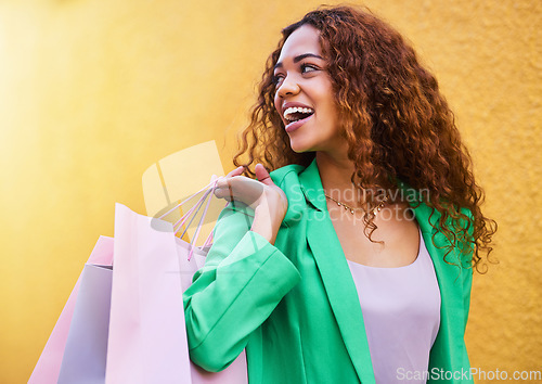 Image of Shopping bag, fashion and black woman isolated on wall background with idea, vision and wealth success for sale. Retail, outdoor and funky model or young customer person walking with discount clothes