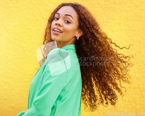 Image of Black woman, fashion and portrait on yellow wall background for motivation, beauty and style. Gen z person with curly hair outdoor for freedom, energy and positive mindset for Opportunity in Colombia