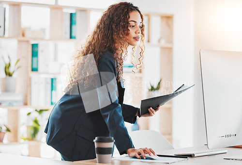 Image of Businesswoman, computer and document in schedule planning, preparation or strategy standing at office desk. Female employee manager checking desktop PC in analysis or project plan at the workplace