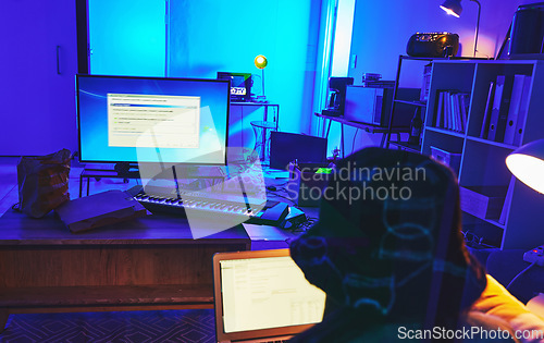 Image of Dark, coding and woman with a computer for hacking, data thief and stealing database information. Criminal, scam and hacker in a room at night for software password, server and network fraud online