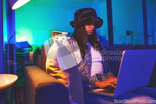 Image of Programmer, hacker and woman typing on laptop in home at night in neon light to hack software. Cybersecurity, ransomware phishing and female coder coding on computer for hacking database with malware