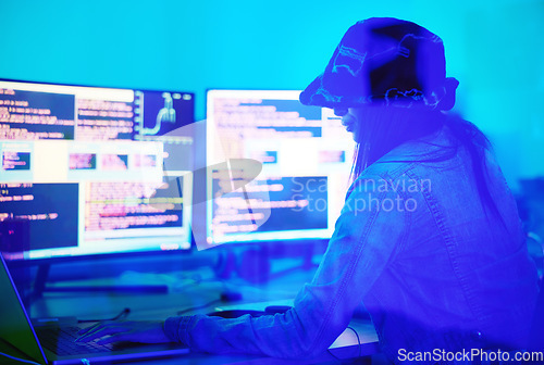 Image of Hacker, programmer and woman typing on laptop in home at night in neon light to hack software. Cybersecurity, ransomware phishing and female coder coding on computer for hacking database with malware