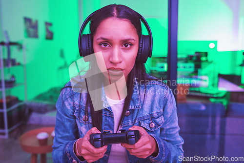 Image of Headphones, portrait or gaming console in neon home with thinking, strategy or planning face expression in PC esports. Video gamer, woman or player in night house basement with cyberpunk technology