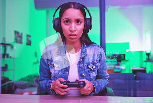 Image of Gamer, headphones and portrait of woman in home at night in neon light for web esports. Gaming face, cyber technology and gen z female with controller playing online games and video game in house.