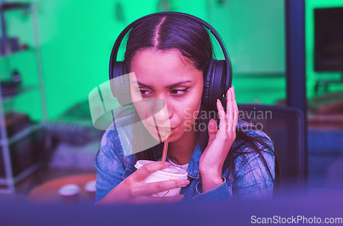 Image of Gamer, headphones and drinking in neon home with bored, tired or annoyed face of girl in PC esports gaming. Woman programmer, drink and thinking in night basement and listening to music or radio