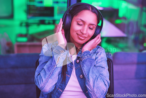 Image of Music headphones, relax and woman in home streaming radio or podcast at night in green neon light. Hacker, it programmer and happy female coder listening and enjoying song, audio or sound in house.