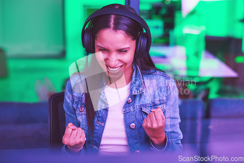 Image of Headphones, success and celebration of hacker on computer after hacking software database. Night winner, neon light and happy woman, programmer and coder streaming music while celebrating winning.