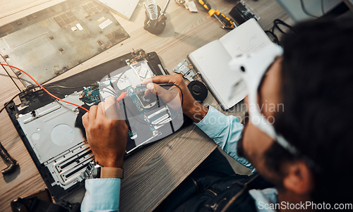 Image of Hardware, engineering and IT professional repair motherboard, microcircuit or electronic device in a workshop or shop. Overhead, man and guy fixing a computer for technology in a lab or factory