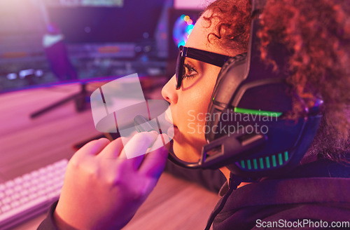 Image of Video game, girl and talking on headphones in home for esports, online games and virtual competition. Female gamer, computer live streaming and gaming in neon lighting, technology and gen z streamer