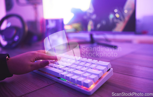 Image of PC keyboard, gaming and hand for video game, online streaming and gamer room in neon light. Woman or person hands typing or press keys on gamer electronics, computer technology and rgb lights closeup