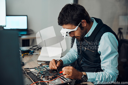 Image of Technician, computer and engineer repair motherboard, microcircuit or electronic device in a workshop or shop. Person, man and guy fixing hardware with electric meter for technology in a lab