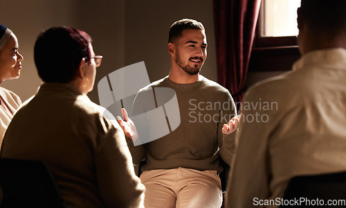 Image of Support, smile and man sharing in group therapy with understanding, feelings and talking in session. Mental health, addiction or depression, men and women with therapist sitting together for healing.