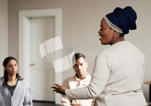 Image of Talking, black woman and group of people in therapy with understanding, sharing feelings and psychology session. Mental health, addiction or depression, men and women with therapist sitting together.