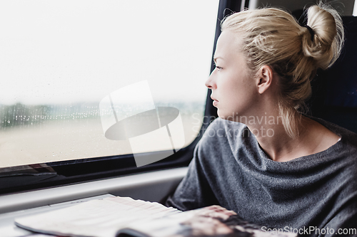 Image of Lady traveling by train.