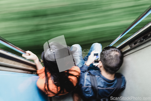 Image of Couple traveling by train. Motion blured image creating impression of movement and speed.