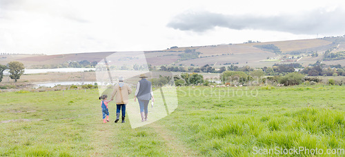 Image of Agriculture, field in countryside with family walking on farm and back view, green and sustainability with agro. Fresh air, farming and farmer with people outdoor, holding hands and environment