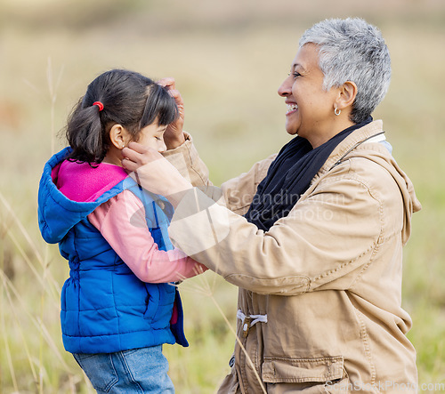 Image of Happy grandmother, young girl and nature walk on farm with senior woman in the countryside. Outdoor field, grass and elderly female with child on family adventure on vacation with happiness and fun
