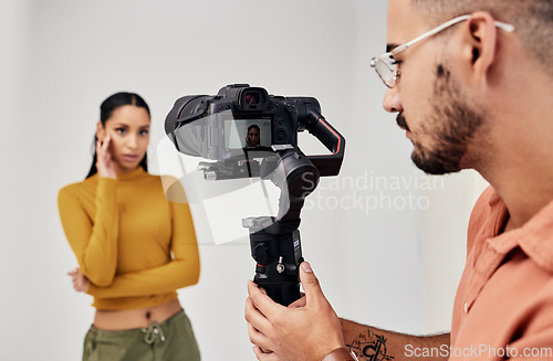 Image of Photography, woman and photographer or cameraman with fashion model in studio for creative, capture and shoot. Media, backstage and professional man with camera, equipment and girl for photoshoot