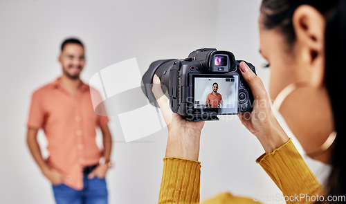 Image of Woman, studio photography and camera with man, model and vision for fashion, magazine or designer. Photographer girl, focus and workspace with background, ideas and photoshoot for clothes design blog