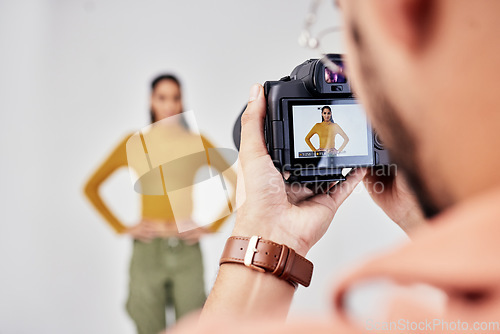 Image of Camera, photography and photographer with woman fashion model in studio for creative, advertising and image. Media, backstage and professional man with girl and equipment for photoshoot capture