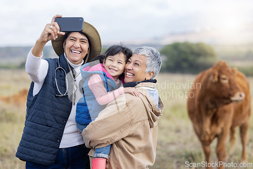 Image of Farm, agriculture and selfie of parents and girl in countryside for holiday, vacation and adventure on field. Lesbian couple, family adoption and photo of child with mom for quality time on cow ranch