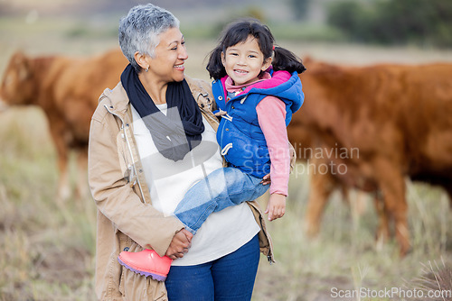 Image of Grandmother, happy girl portrait and nature with cows and senior woman in the countryside. Outdoor field, hug and elderly female with child on a family adventure on vacation with happiness and fun