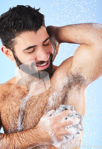 Image of Showering, man and foam with arm pit, cleaning and skincare for dermatology and wet body against blue studio background. Male, gentleman and morning routine for daily hygiene and grooming on backdrop