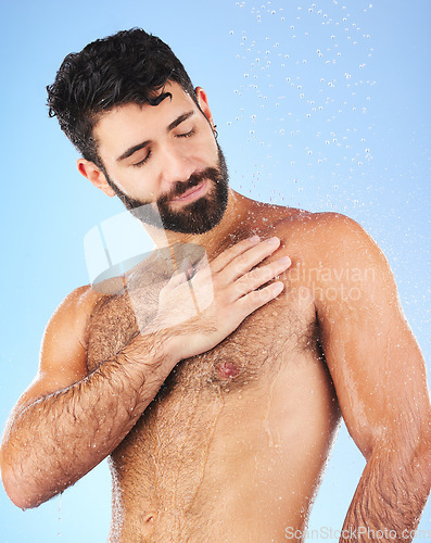Image of Water drops, shower and man for hygiene self care and cleaning on a blue background in studio. Body of a aesthetic model person for skincare, health and wellness with splash for dermatology cosmetics