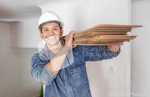 Image of Construction worker, home renovation and portrait of man holding wood for maintenance. Working, smile and house development project employee and builder or handyman for architecture or industrial job