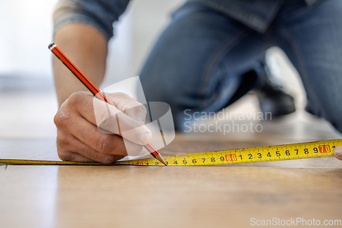 Image of Handyman, floor and hands to measure with pencil, tape and diy for home improvement, maintenance and building. Builder, construction worker and flooring with writing, planning and vision in workplace