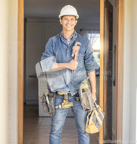 Image of Handyman in portrait, maintenance job and tools with construction and home renovation, builder with smile. Professional contractor, DIY skills and manual work with wrench, male with helmet for safety