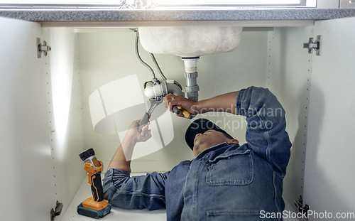 Image of Plumber, man and handyman with plumbing, home renovation and manual labour with tools. Construction, DIY skills and professional, fixing pipe in industry and male with trade, repairs and maintenance