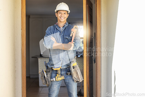 Image of Handyman in portrait, maintenance and tools with construction and home renovation, builder with smile. Professional, contractor and DIY skills, architecture and wrench, male with helmet for safety