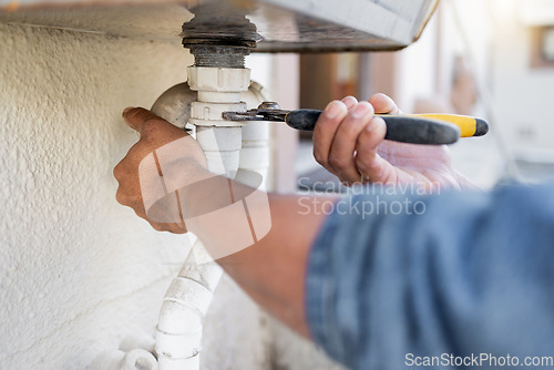 Image of Hands, plumber and wrench for pipe, maintenance and repairs, blockage and installation by man closeup. Plumbing, zoom and professional handyman fixing drain, system and replace with tool or equipment