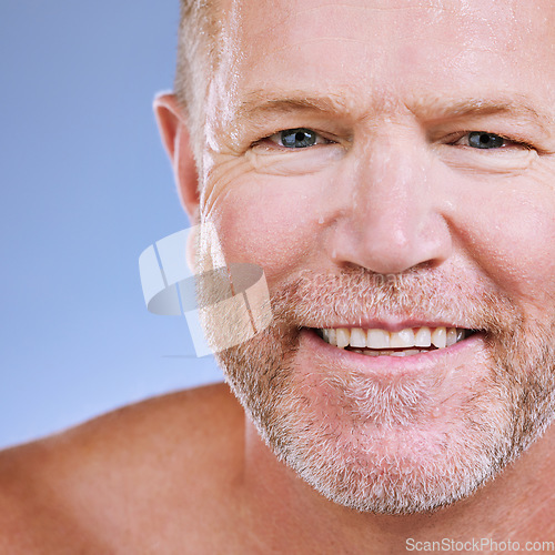 Image of Skincare zoom, smile and portrait of a mature man in a blue background studio with mockup. Facial, cosmetics wellness and spa treatment of a senior model with happiness from self care cleaning