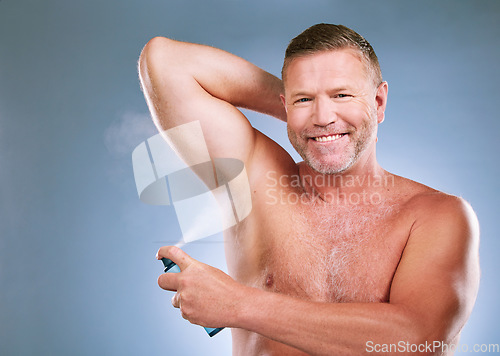 Image of Man, armpit and deodorant in skincare hygiene, grooming or smelling fresh against a studio background. Portrait of elderly male smiling and spraying under arms for aroma or clean cosmetics on mockup
