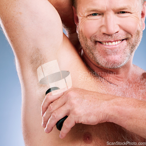 Image of Man, smile and shaving armpit in skincare hygiene, grooming or hair removal against a studio background. Portrait of elderly male smiling in beauty epilation for under arm shave and clean cosmetics