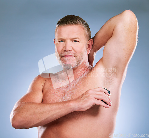 Image of Man, shaving armpit and skincare hygiene, grooming or body care against a studio background. Portrait of elderly male model smiling in satisfaction for shave, hair removal or clean cosmetic treatment