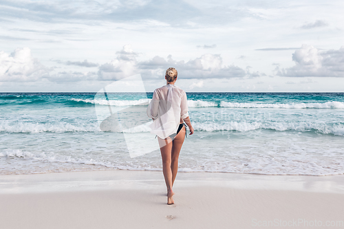 Image of Woman on summer vacations at tropical beach of Mahe Island, Seychelles.