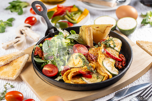 Image of Omelet served with salad