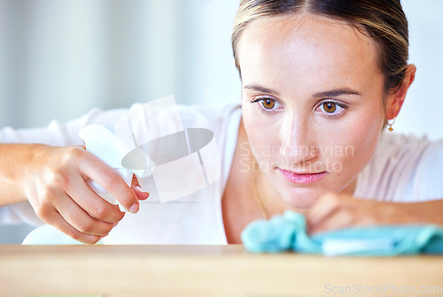 Image of Spray, looking and woman cleaning table of dirt, bacteria and product. House, service and cleaner working on desk or counter for housework and routine chores while wiping and spraying with detergent