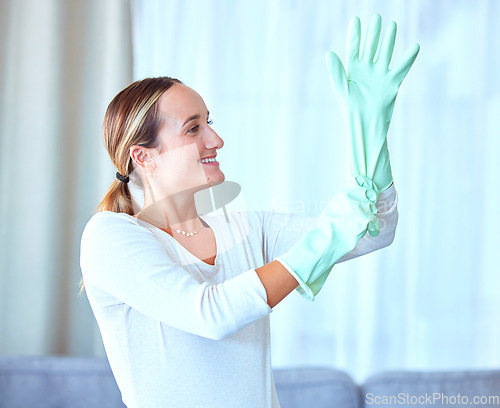 Image of Woman, gloves and cleaning for hygiene, disinfectant and cleaner ready to start the day, housekeeping and sanitary. Female, lady and maid in living room, dust and dirt with bacteria and rubber safety