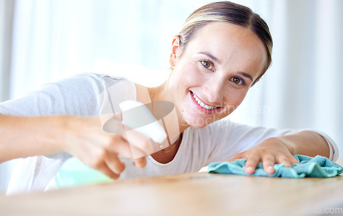 Image of Portrait, woman and cleaning with spray bottle, cloth and smile for hygiene, disinfectant and dusting. Face, female cleaner or maid with liquid, rag or housekeeping with furniture or sanitize surface