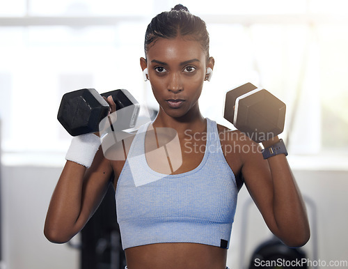 Image of Woman, fitness and weightlifting dumbbells at gym for intense exercise, workout or strength training. Serious female lifting weights and exercising for healthy wellness or bodybuilding at health club