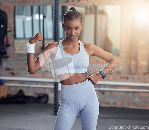 Image of Woman, fitness and portrait flexing bicep for empowerment, exercise or workout at the gym. Portrait of serious female in flex showing arm muscle, strength or power for healthy wellness at health club