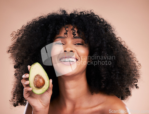 Image of Black woman, studio portrait and avocado with smile, skincare and health with self care wellness by background. Happy gen z model, African and fruit for natural cosmetics, healthy nutrition or diet