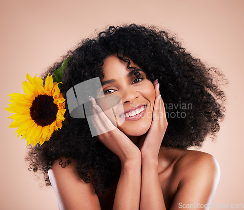 Image of Black woman, studio portrait and sunflower with skincare, beauty or cosmetic wellness by beige background. African gen z model, flower and spring aesthetic with happiness, self care or natural makeup