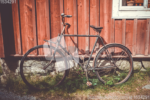 Image of Old bicycle on a wooden wall