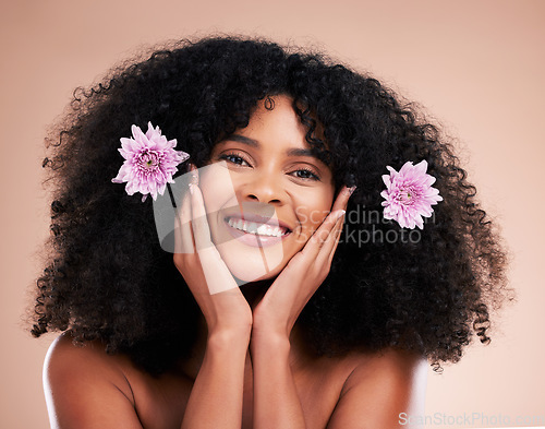 Image of Face, portrait and black woman with flowers for hair care in studio isolated on a brown background. Floral cosmetics, hairstyle makeup and beauty of happy female model with plant for salon treatment.