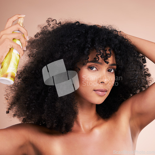 Image of Black woman, portrait and afro hair spray on isolated studio background for frizz control, curly management or oil treatment. Beauty model, face and natural haircare product for self love or grooming